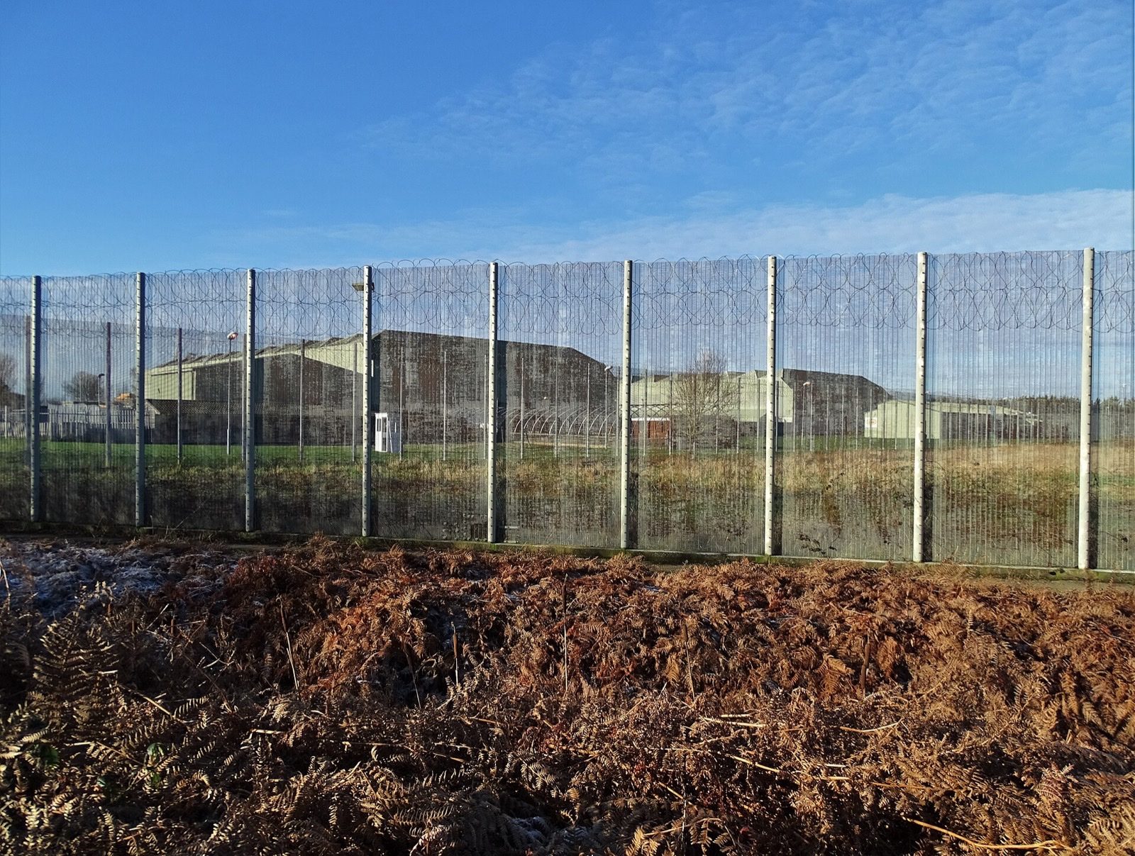 Tall security fences around a correctional facility