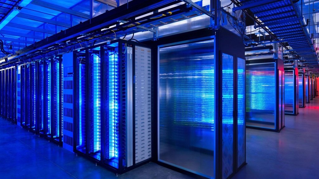 Server aisle inside a data hall lit in blue